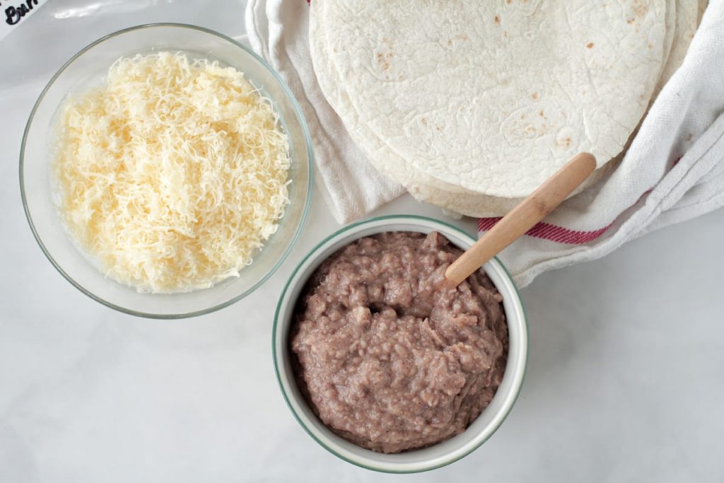 Super easy FREEZER bean burritos made with REAL ingredients the whole family loves. This recipe is a family-favorite for quick lunches and dinners.
