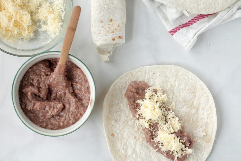 Super easy FREEZER bean burritos made with REAL ingredients the whole family loves. This recipe is a family-favorite for quick lunches and dinners.