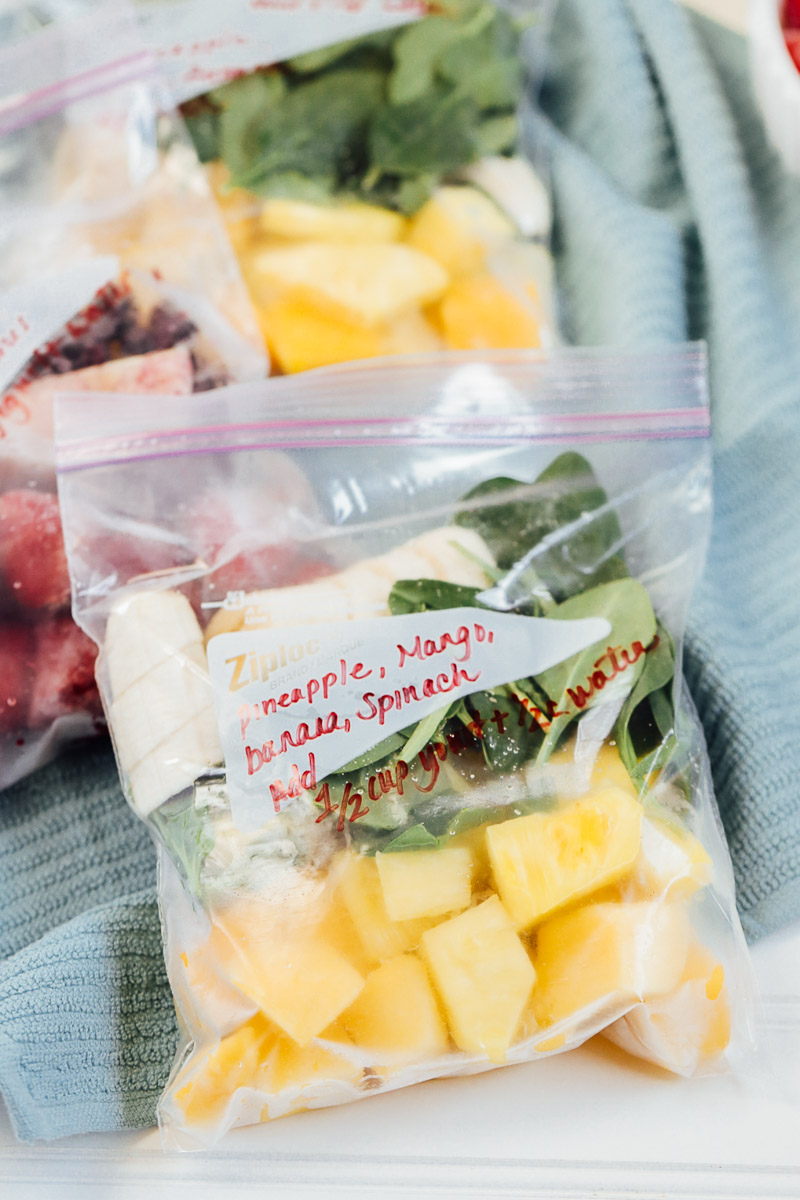 Meal prep smoothie pack with pineapple, mango, banana, and spinach inside a baggie.