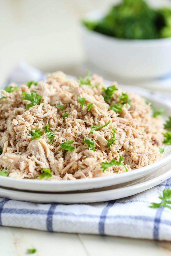 How to make super easy crock-pot shredded chicken using a whole chicken! Save money and time every week with this simple prep day method. Plus, ideas for using shredded chicken for quick, healthy meals!