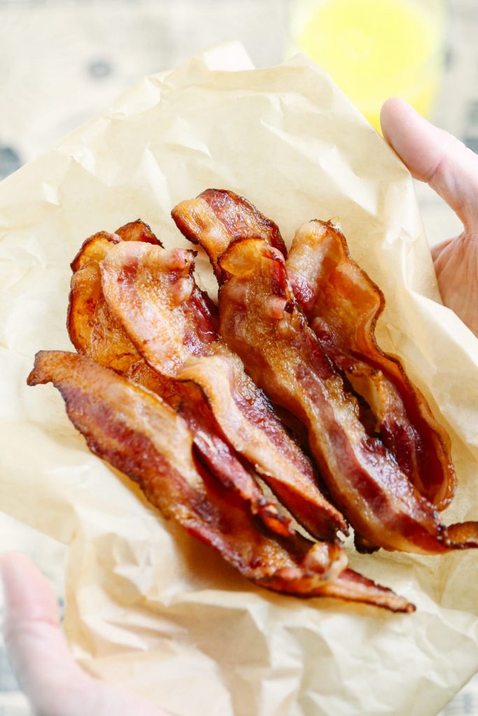 The BEST way ever to cook bacon. No grease splatters. No grease spills. Perfectly crispy bacon every single time. I won't ever go back to cooking bacon on the stove-top or griddle. So easy! Oven-baked bacon is the way to go.