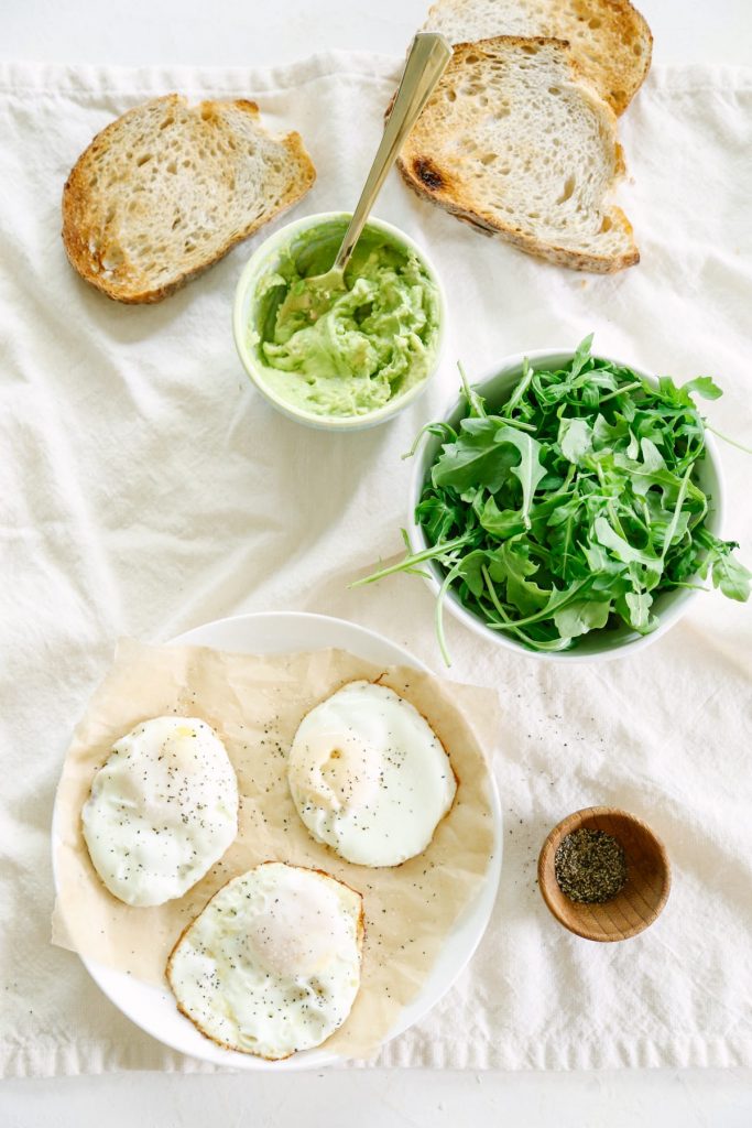 This avocado toast with egg and arugula is amazing! You can play around with herbs and spices to make a different toast each time!