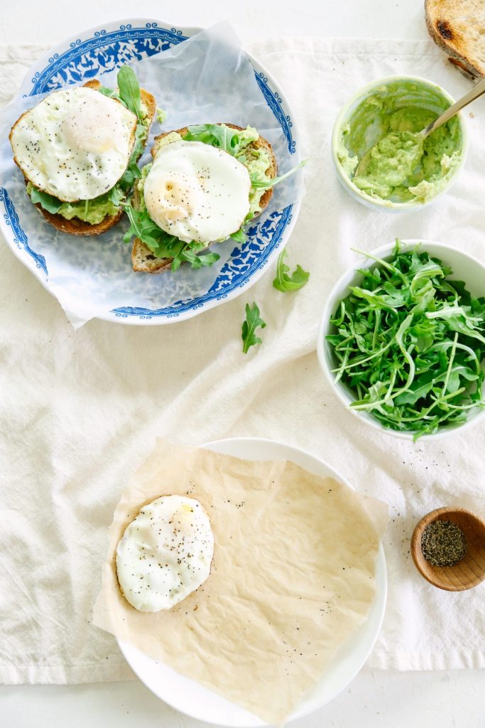 This avocado toast with egg and arugula is amazing! You can play around with herbs and spices to make a different toast each time!