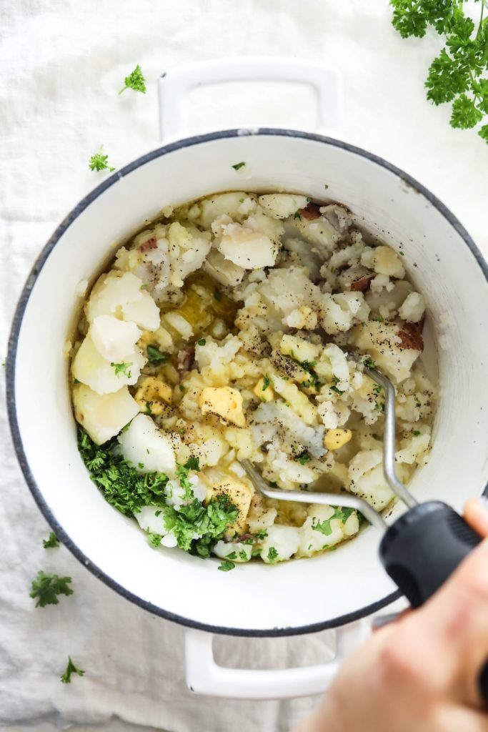 Lightened-Up mashed potatoes with herbs! So easy (no mixer required)--just add butter and olive oil, and mix. From-scratch mashed potatoes.