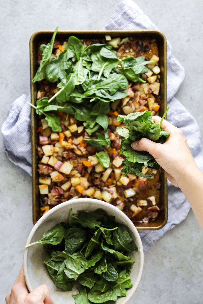 Sheet pan veggies and bacon, eggs, cilantro, avocado, and salsa come together in these loaded breakfast-style burritos. So flavorful and easy! Vegetarian option, too.