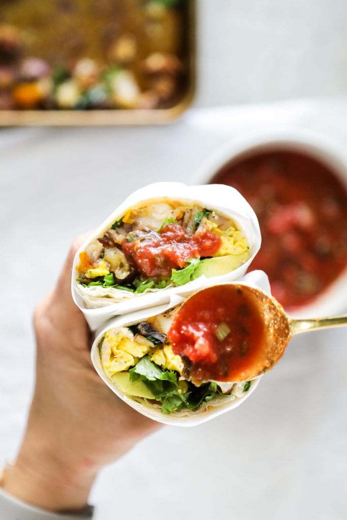Sheet pan veggies and bacon, eggs, cilantro, avocado, and salsa come together in these loaded breakfast-style burritos. So flavorful and easy! Vegetarian option, too.