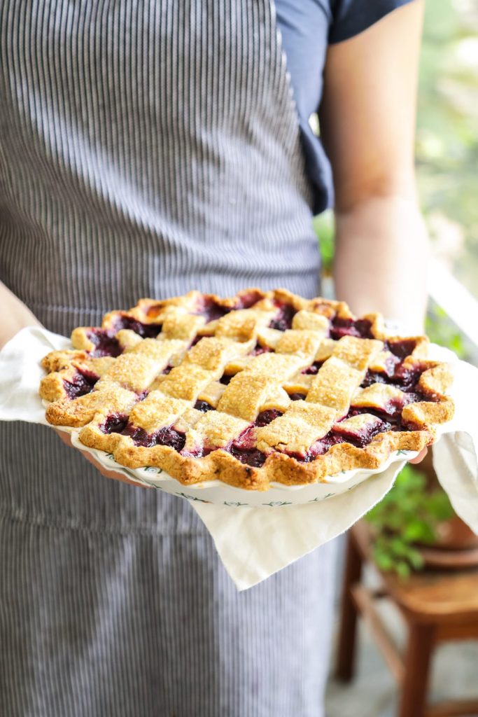 A homemade mixed berry pie featuring frozen (summer) berries and a flaky, homemade crust.