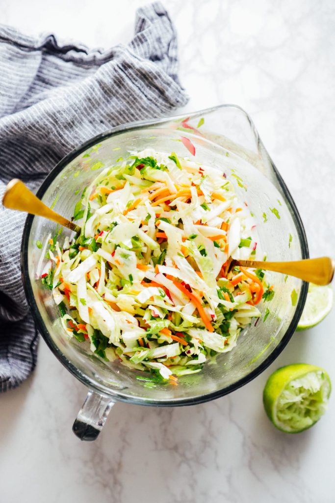 This winter slaw made with kohlrabi, cabbage, radishes, and carrots is an easy and flavorful winter side dish perfect for tacos and sandwiches!