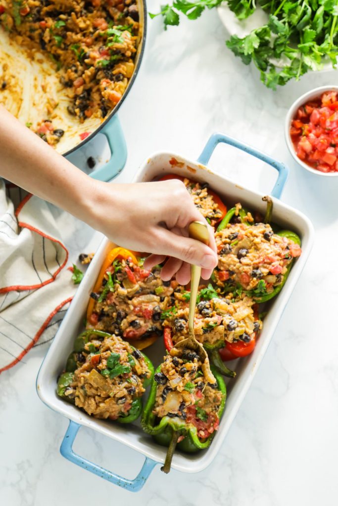 Hearty, vegetarian-stuffed peppers with a Tex-Mex-style filling of beans, rice, salsa, and taco seasonings. Make this meal for dinner, or prep the peppers in advance for a real-food lunch.