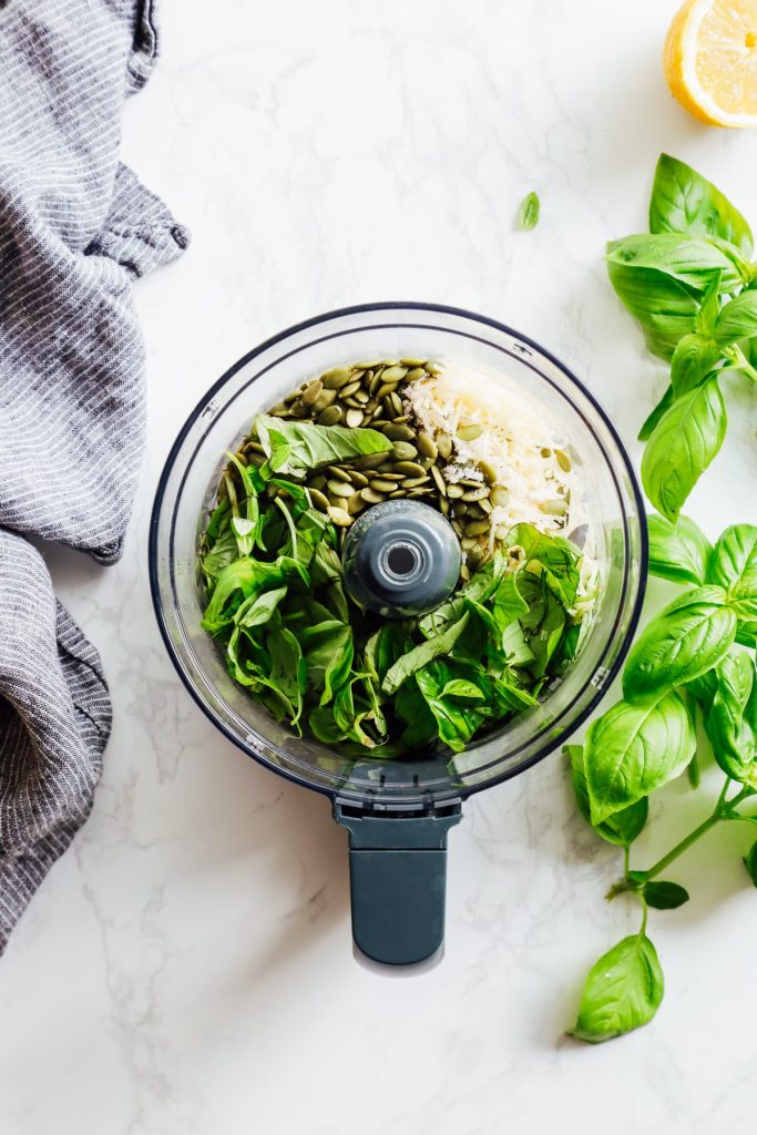 From-scratch pesto is combined with pasta, chicken, and roasted veggies for a make-ahead pasta bowl-style meal. Easy, fresh, real, and make-ahead friendly!