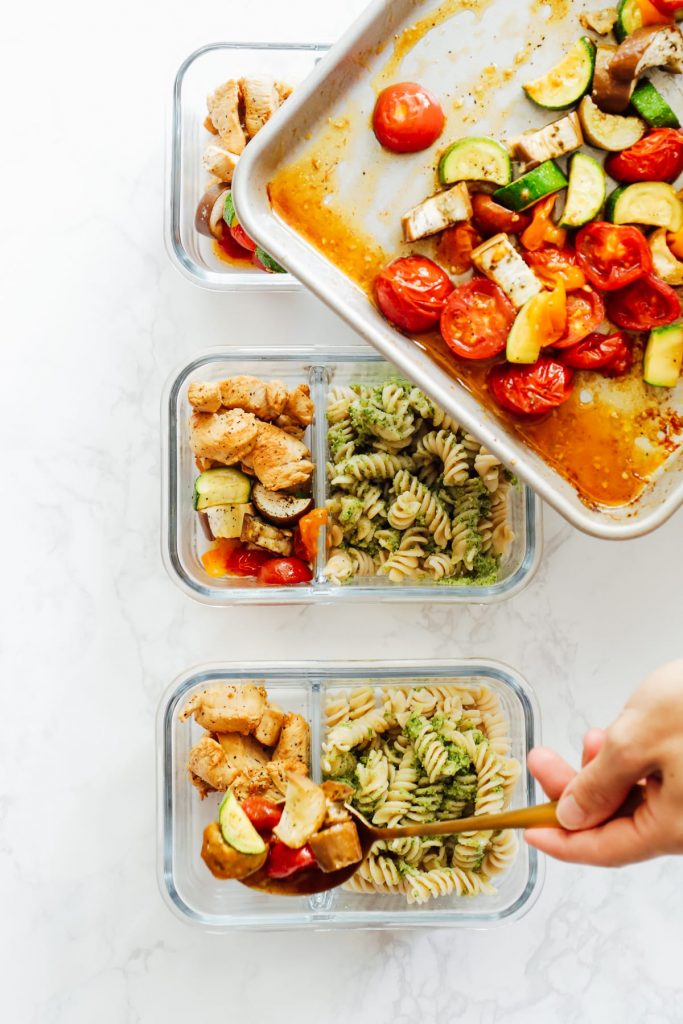 From-scratch pesto is combined with pasta, chicken, and roasted veggies for a make-ahead pasta bowl-style meal. Easy, fresh, real, and make-ahead friendly!