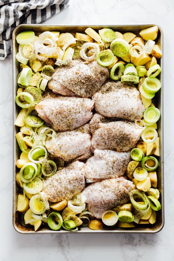 An easy-to-make sheet pan meal made with the simplest of ingredients: chicken thighs, leeks, potatoes, garlic, lemon, and seasonings.