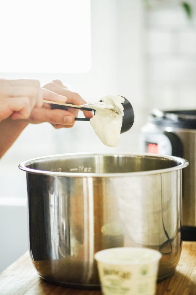 Adding the yogurt starter to the milk