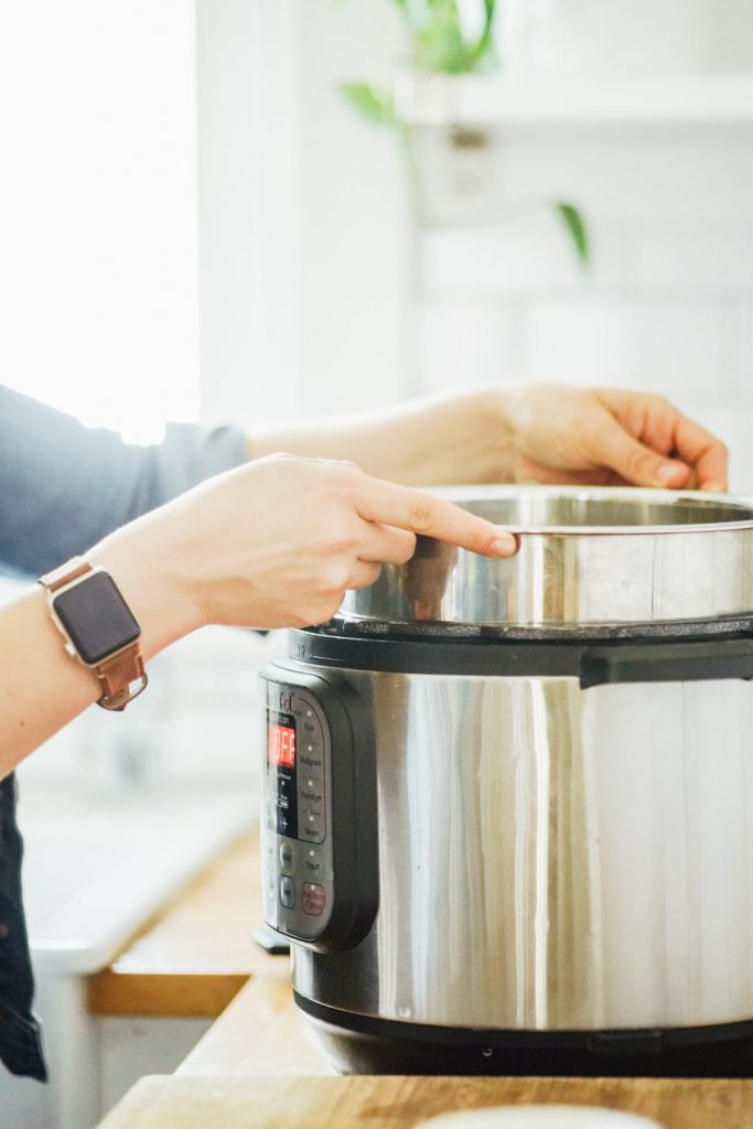 Placing the Instant Pot liner, filled with milk and yogurt stater, in the Instant Pot