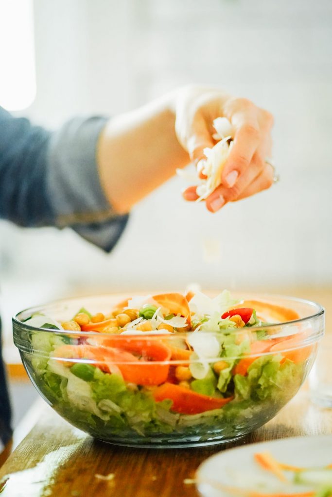 adding cheese to a salad