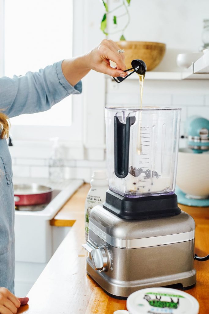 adding honey to the blender