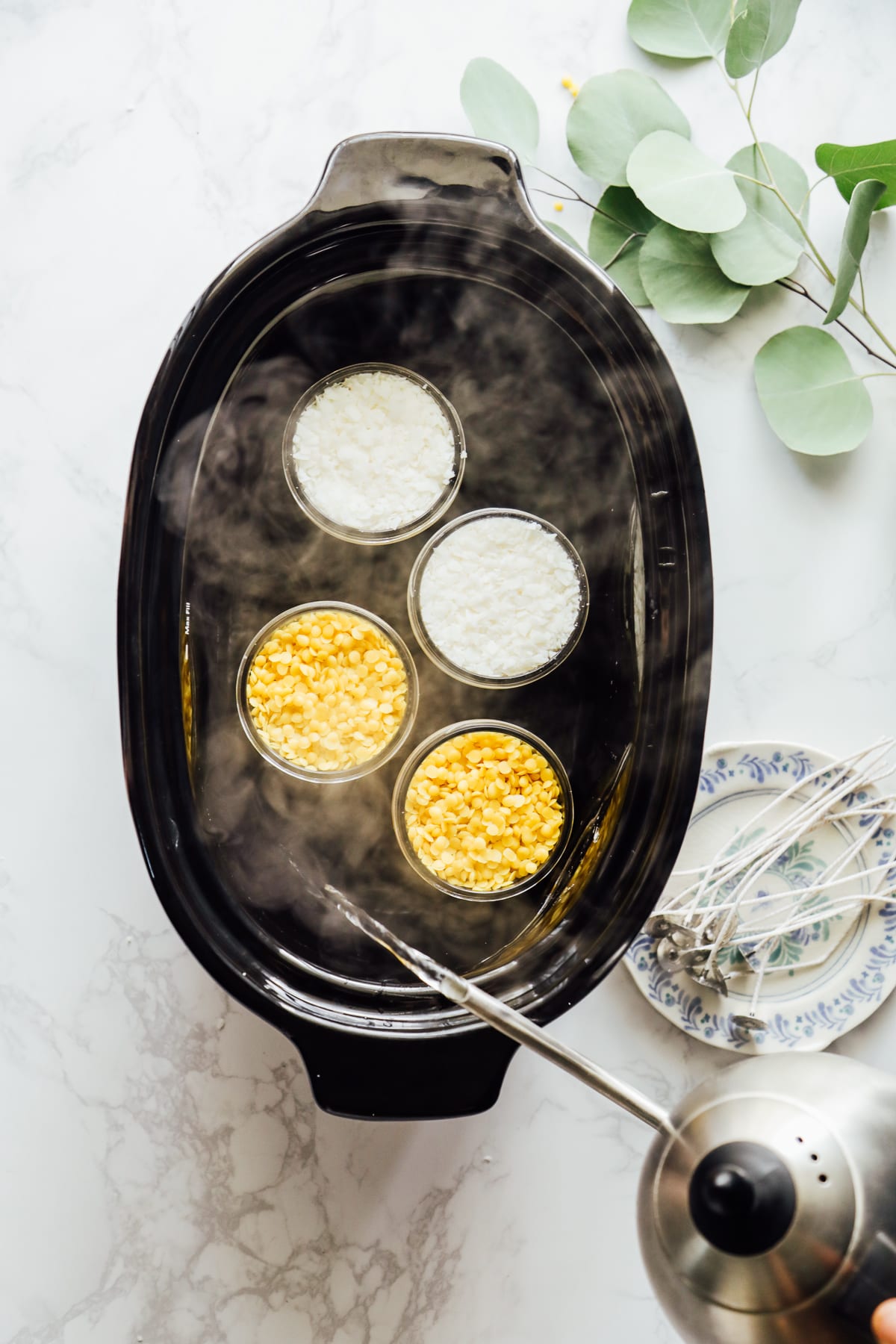 adding boiling water to the slow-cooker to make candles