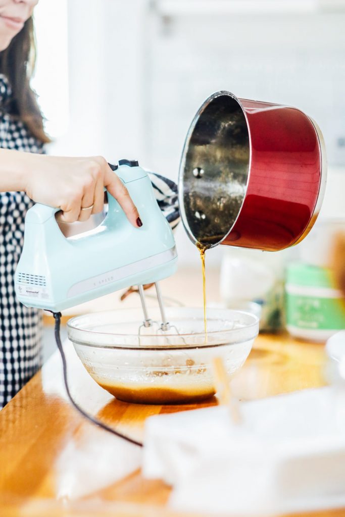 pouring maple syrup into the gelatin to make marshmallows