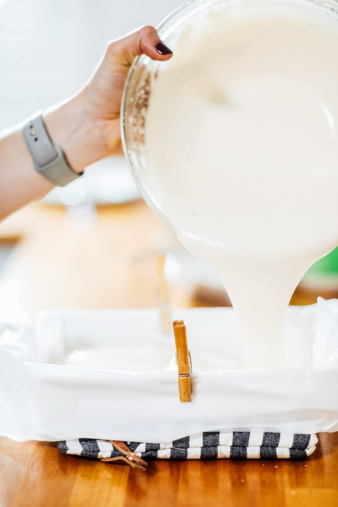 pouring marshmallow fluff into a pan to set