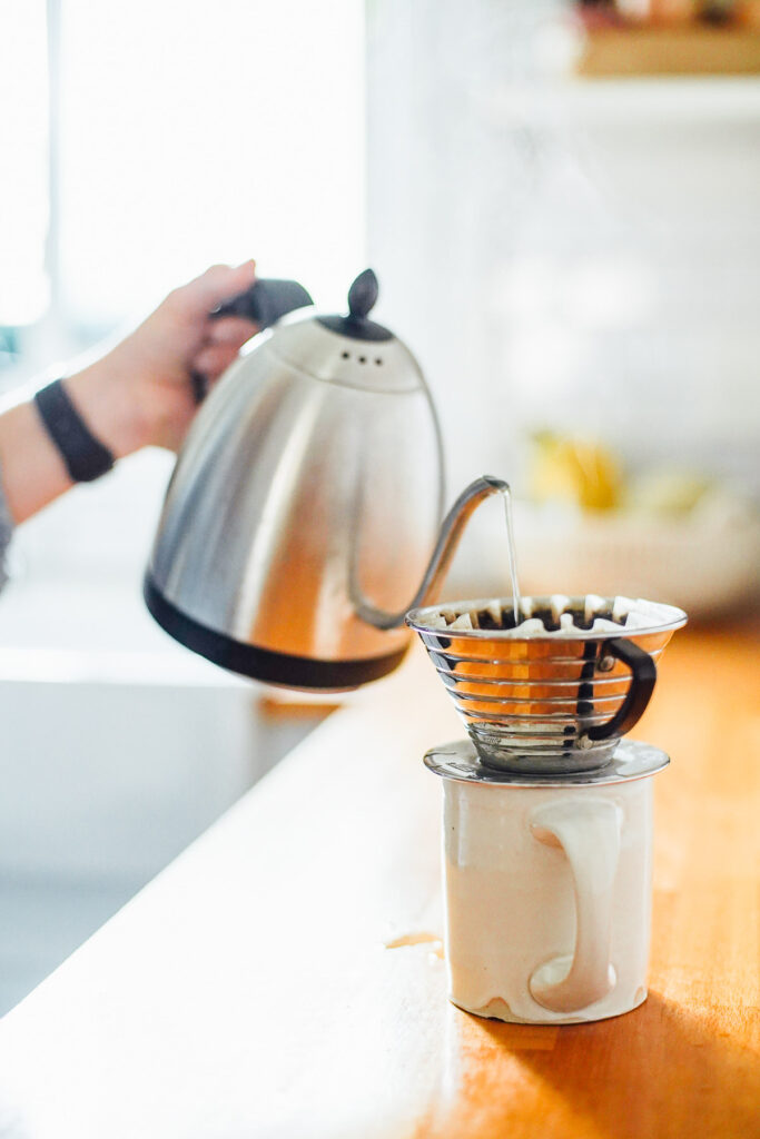 Pour hot water over a coffee maker into a mug.