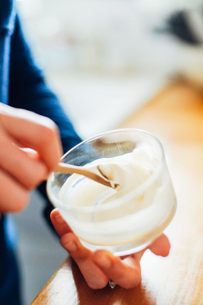 Stirring yogurt to make mask 