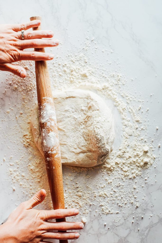 rolling out pizza dough for homemade pizza lunchable