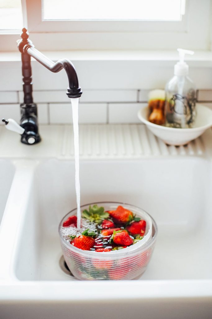 strawberries in sink for vinegar bath