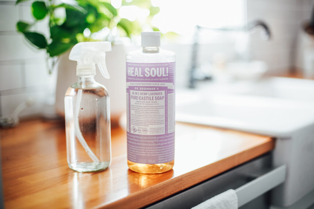 Lavender scented soap in a  bottle on the kitchen counter.