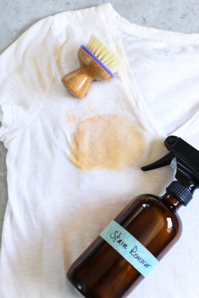 Stain remover made with castile soap and a white shirt with a ketchup stain.