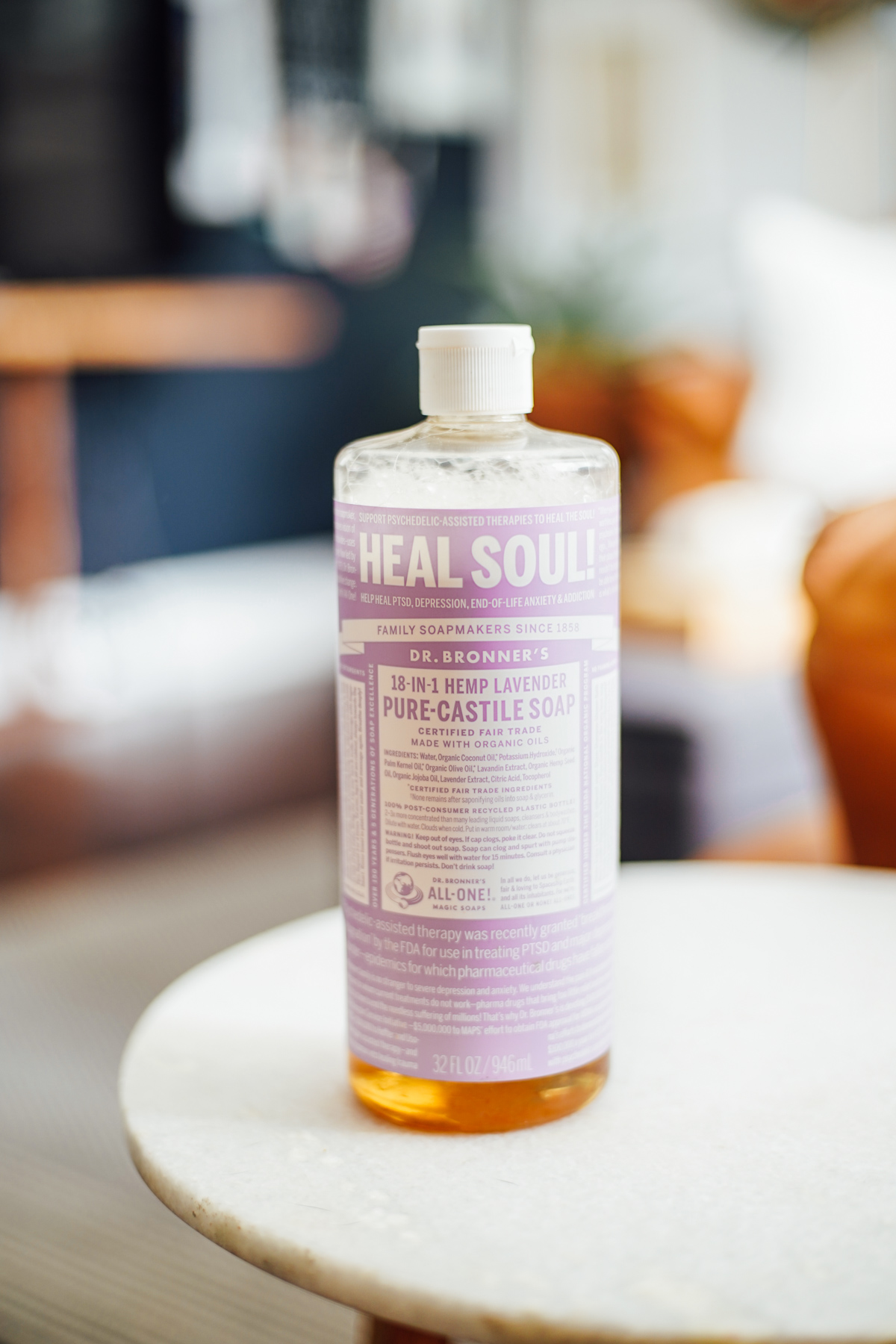 32-ounce liquid castile soap bottle in lavender scent on a table in a living room.