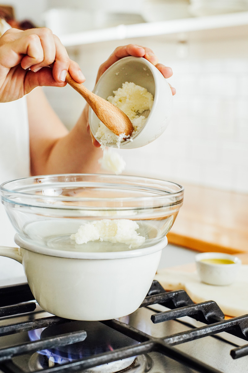 Melt the shea butter in a glass bowl over a saucepan filled with water.