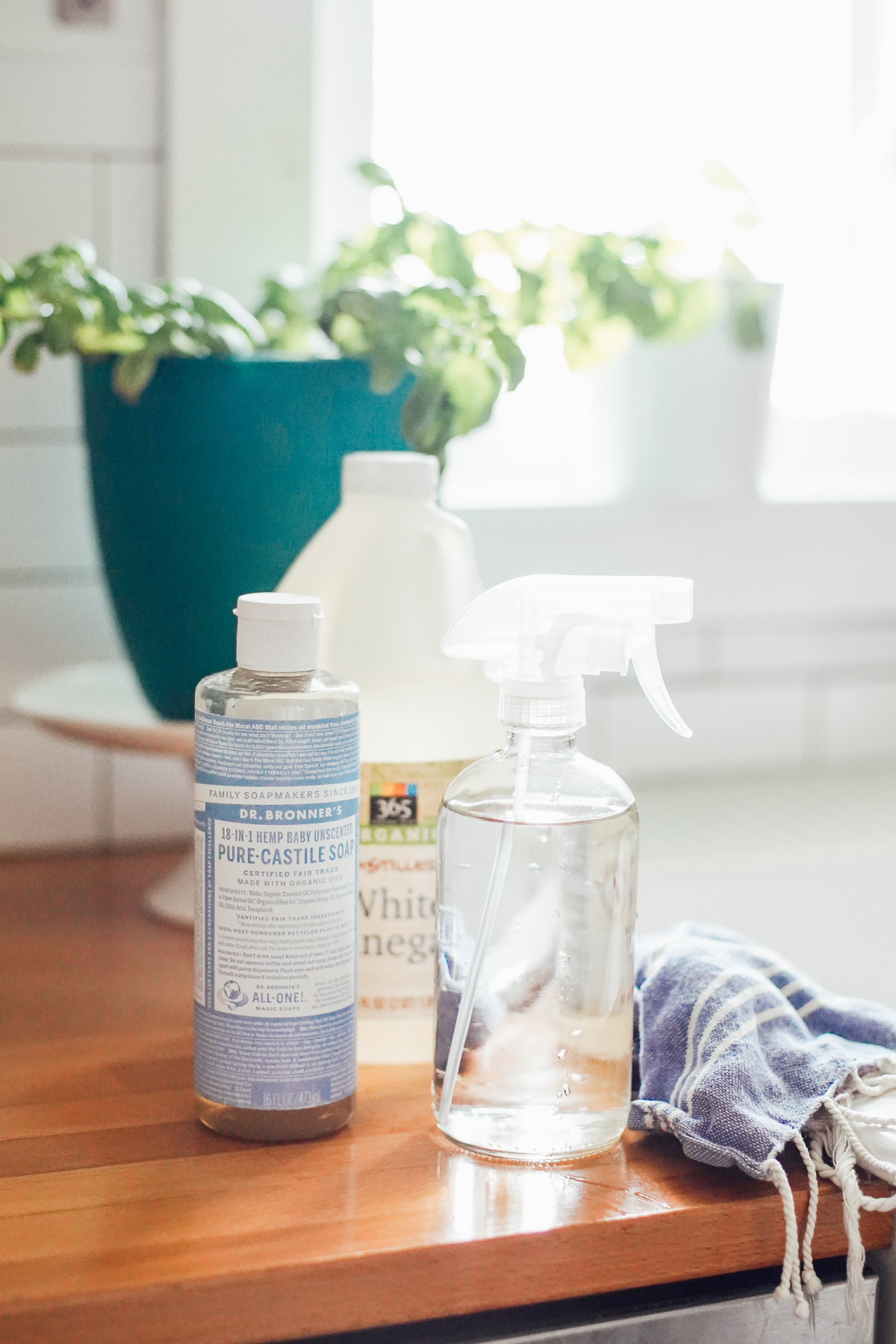All purpose cleaner spray made with castile soap in a clear glass spray bottle.