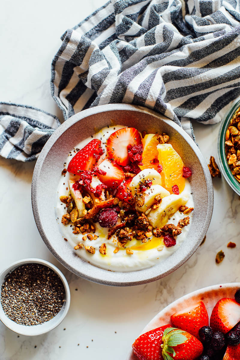 Yogurt bowl filled with fruit and granola.