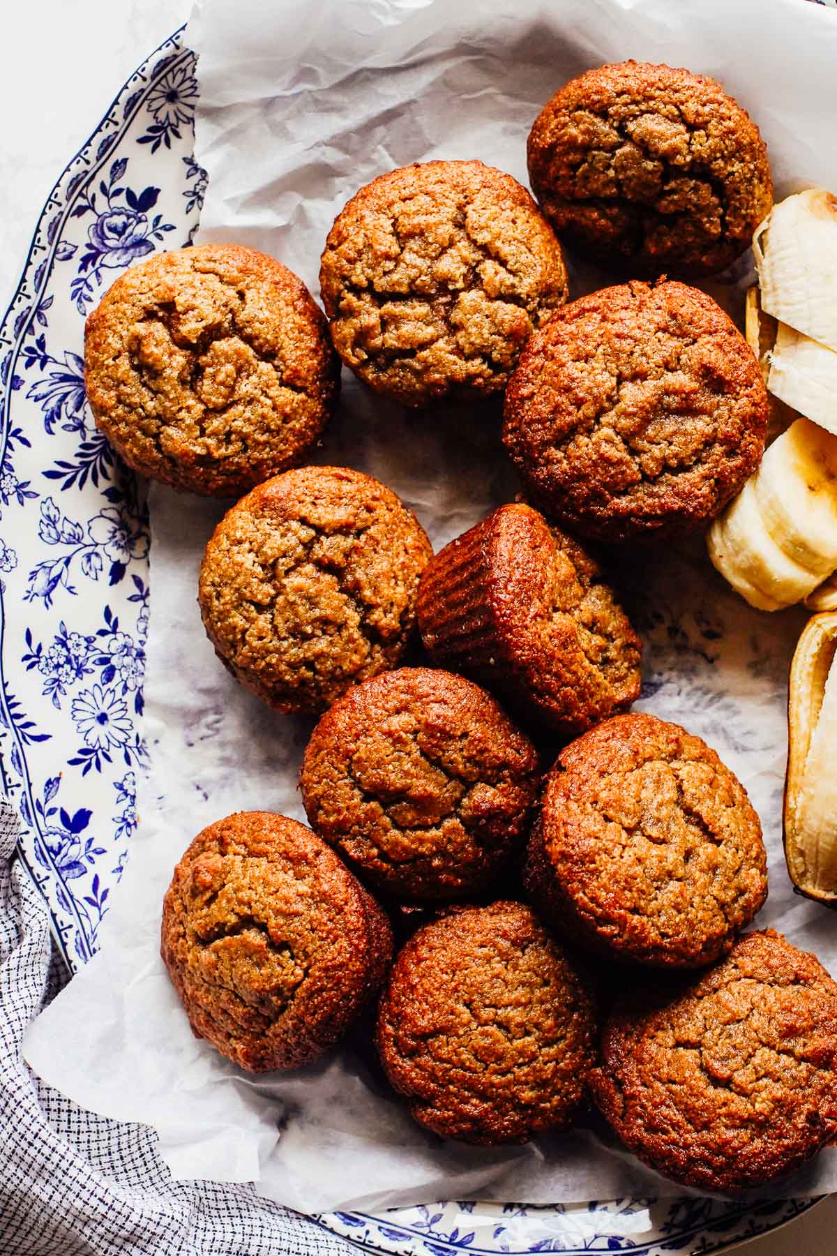 Banana muffins on a plate, all piled together.