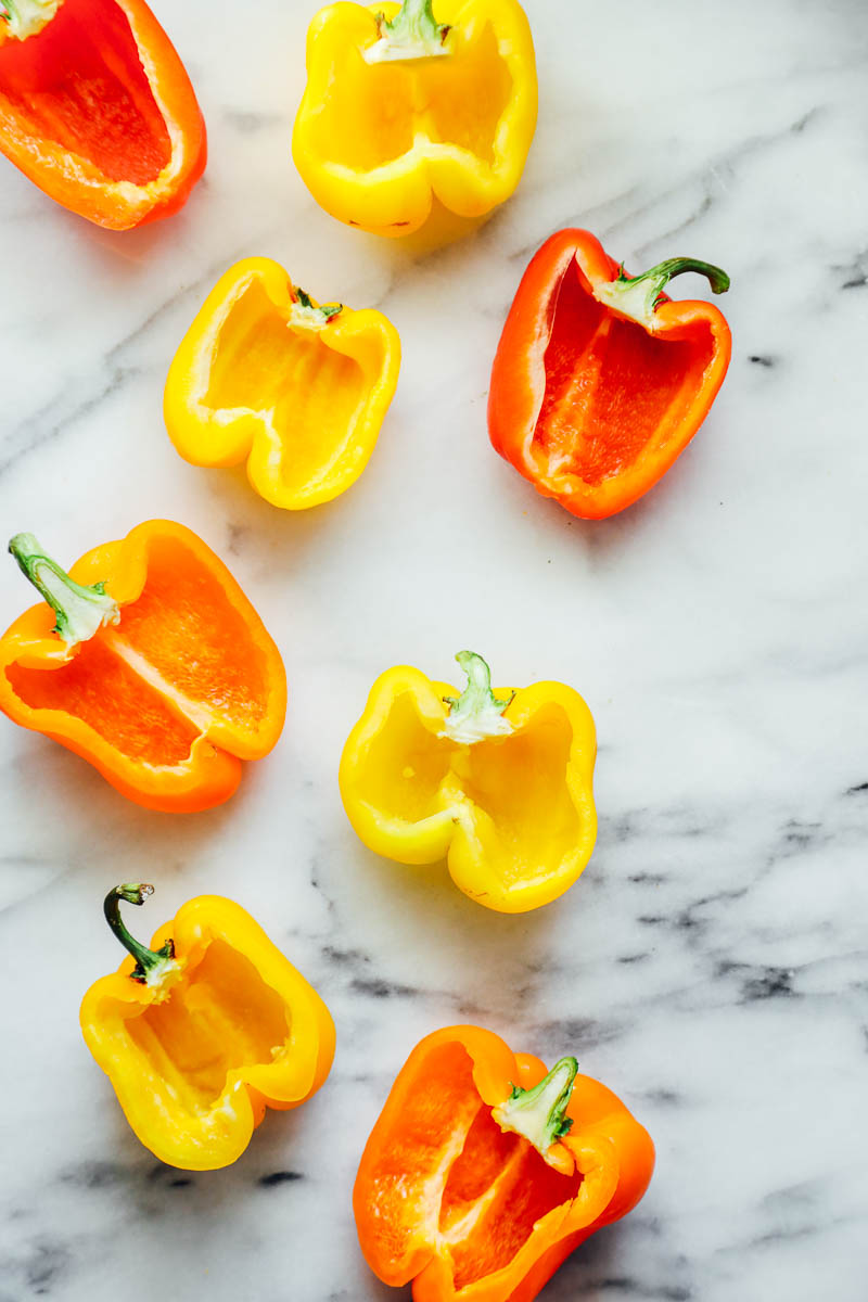 Bell peppers cut in half on a countertop.