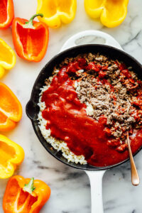 Ground beef, rice, and the tomato mixture in a skillet.