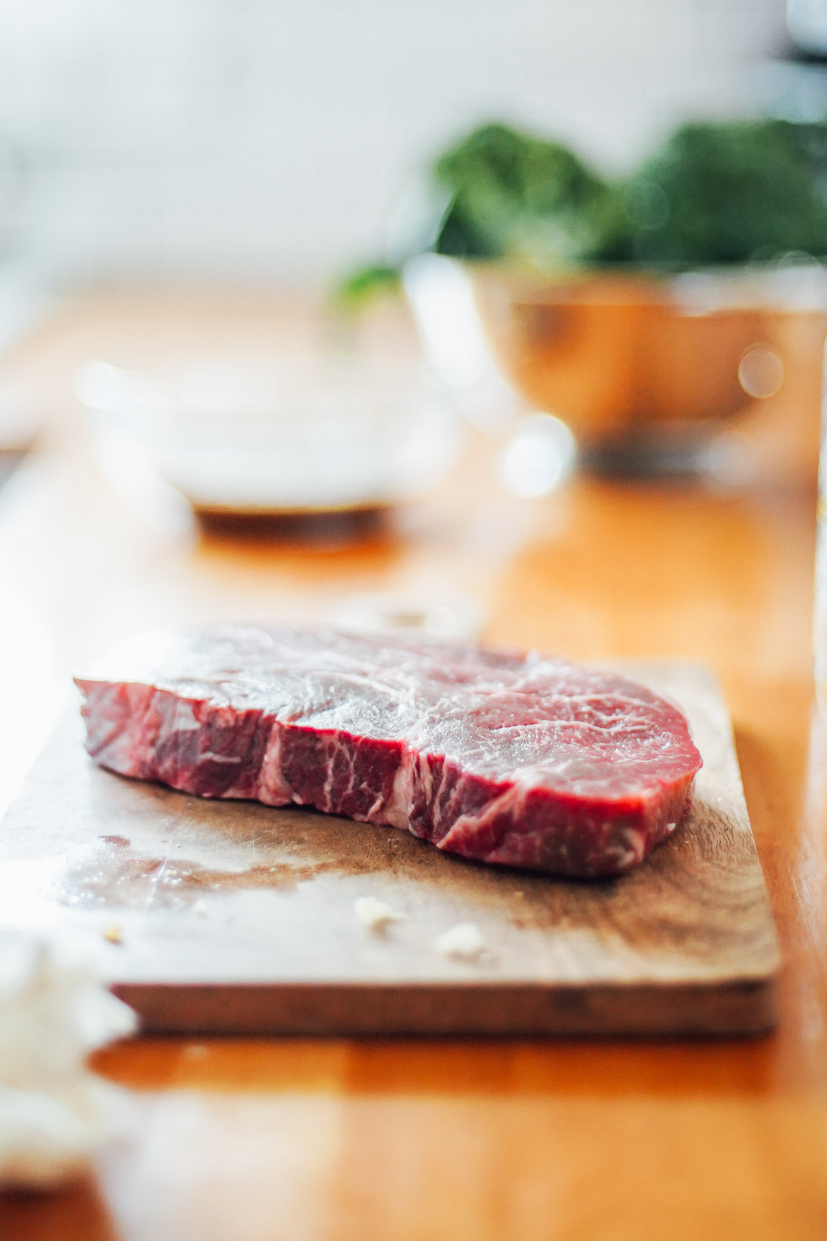 Top sirloin steak on a cutting board.