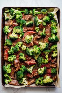 Broccoli and steak slices on the sheet pan ready to bake.