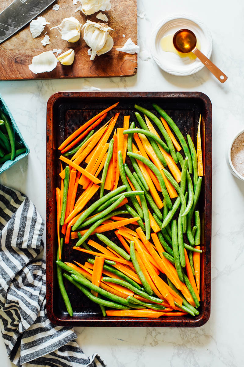 Cut carrots and green beans on a large sheet pan.