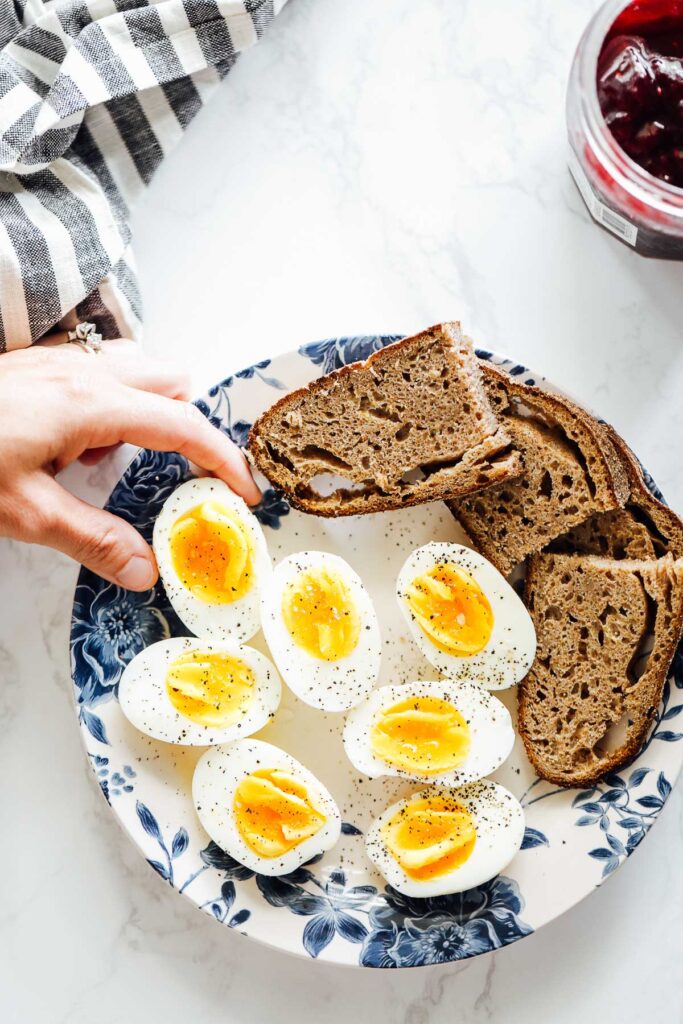 Hard boiled eggs on a plate with sourdough toast.