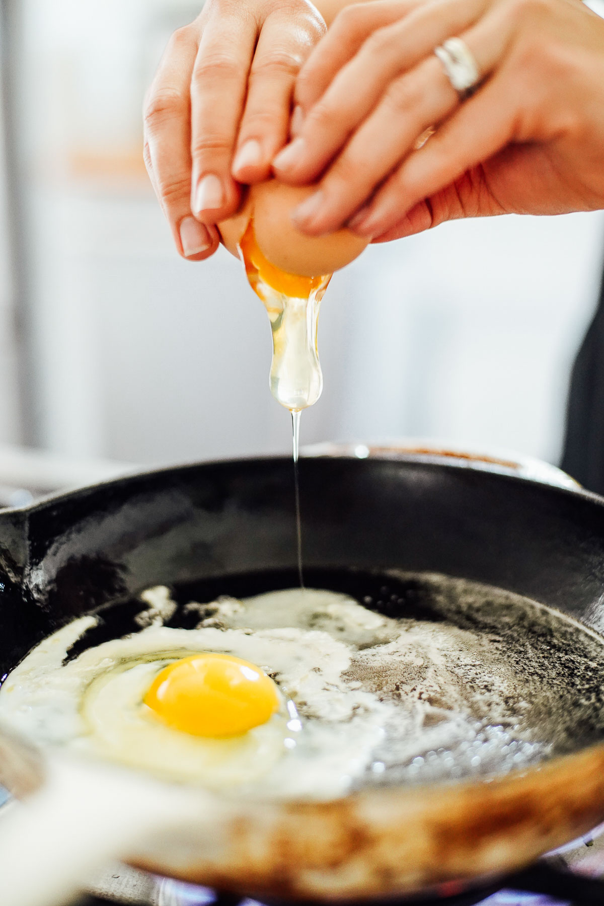 Making sunny side up eggs in a cast iron skillet.