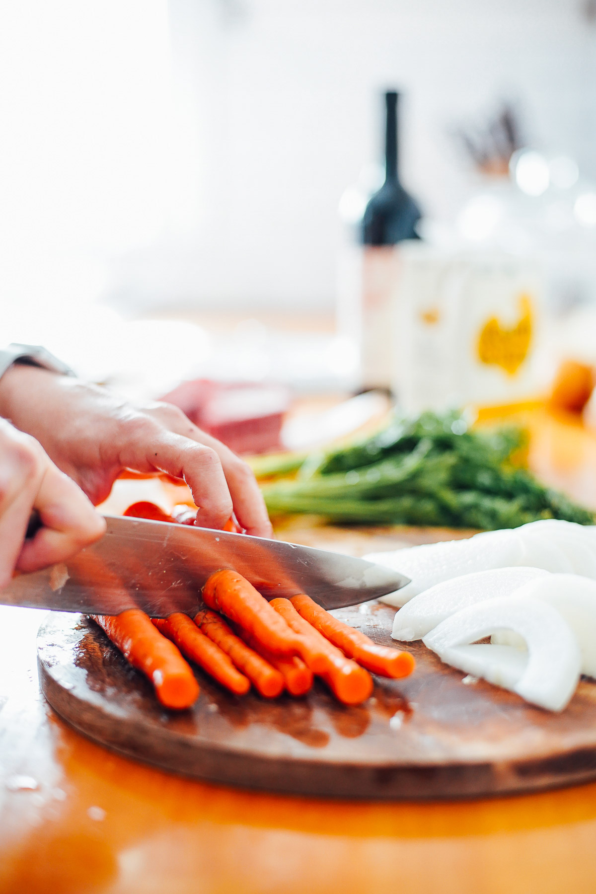 Cutting carrots on a cutting board.