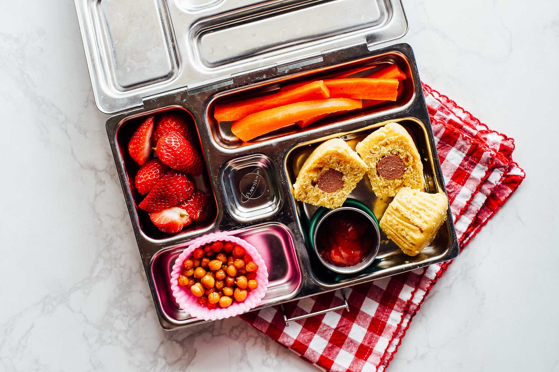 Lunchbox idea: corn dog muffins, crispy chickpeas, carrots, and strawberries.