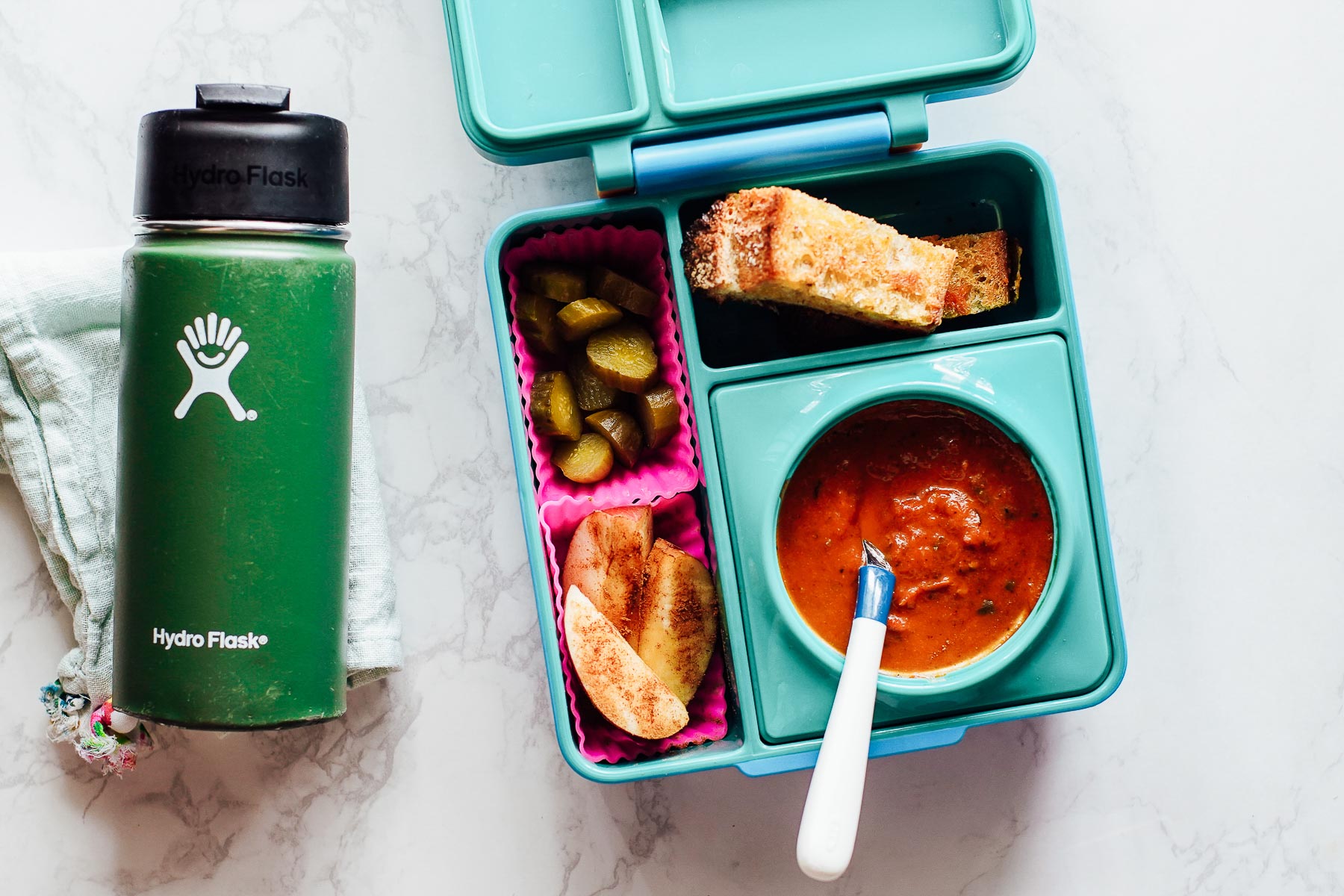 Lunchbox idea: tomato soup, grilled cheese sticks, pickles, and apple slices.
