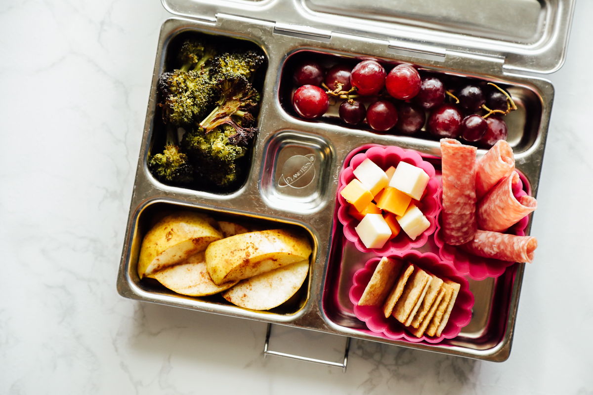 Homemade Lunchable: crackers, cheese, salami with roasted broccoli, pears, and grapes.