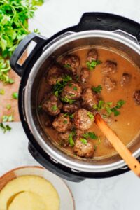 Cooked Swedish meatballs in a gravy sauce in the Instant Pot after cooking.