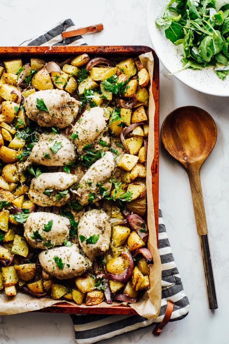 Boneless, skinless chicken thighs baked on a sheet pan with roasted gold potatoes.
