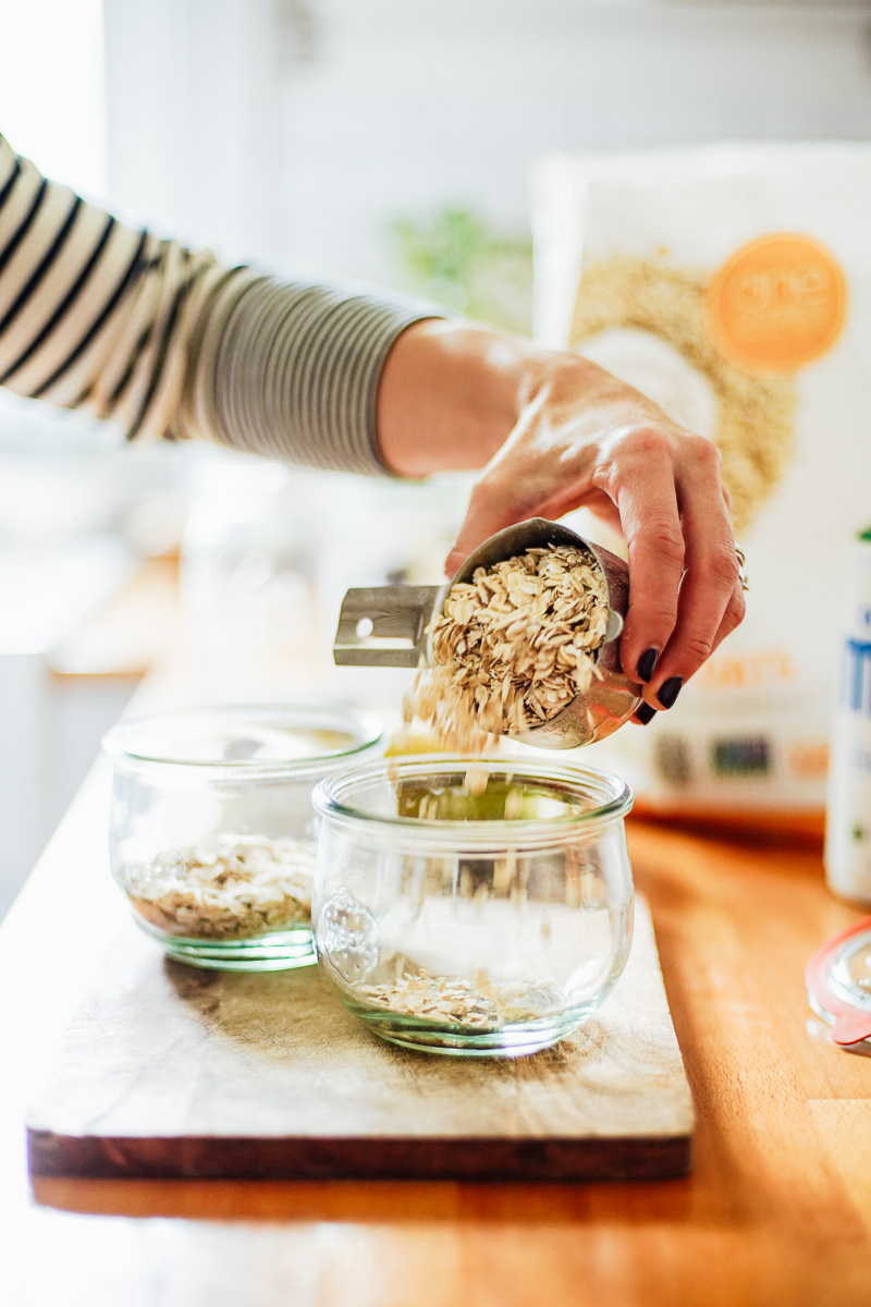 Adding the dry oats to a glass bowl.