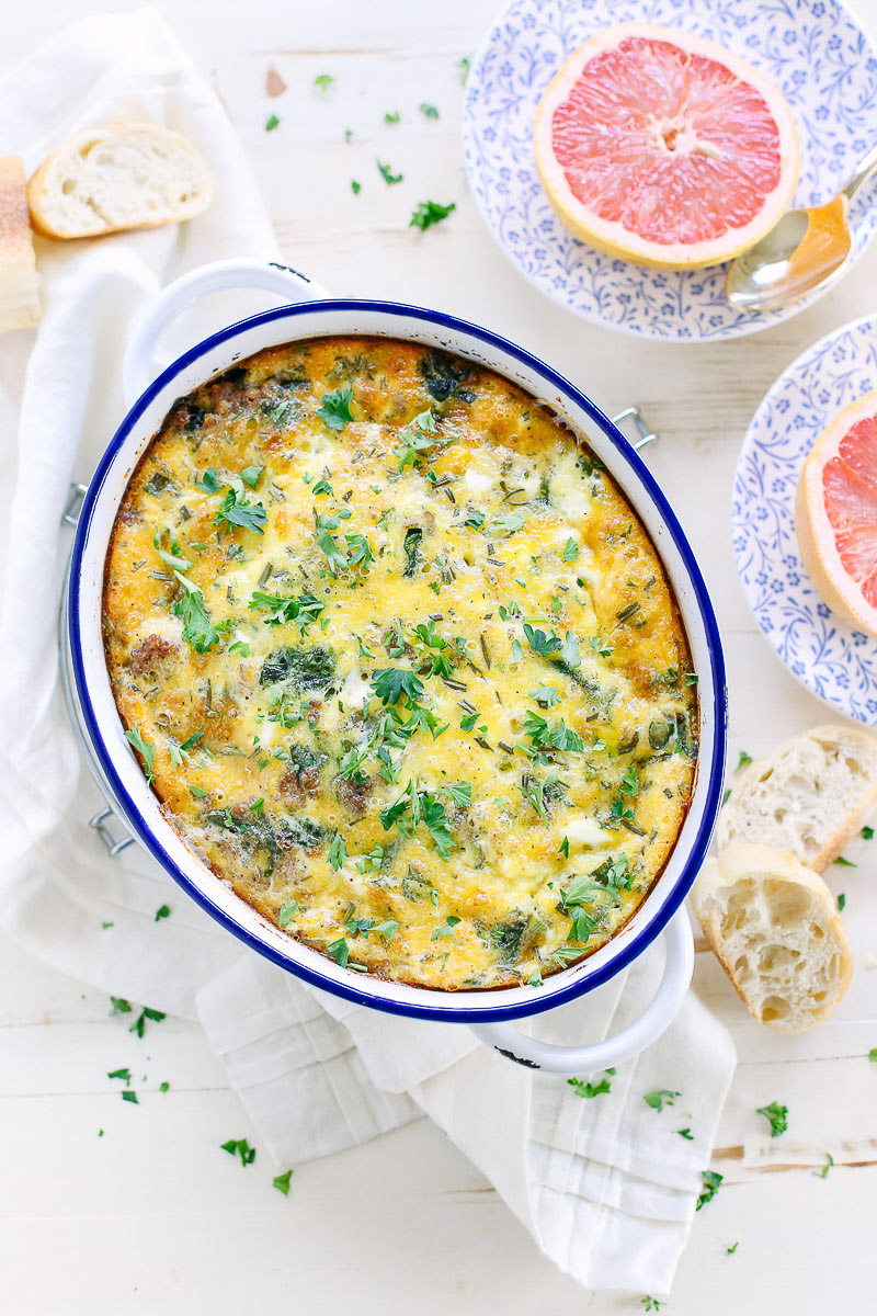 Breakfast casserole served with bread and grapefruit.