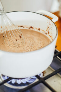 Whisking the hot chocolate ingredients over a medium flame on the stove-top.